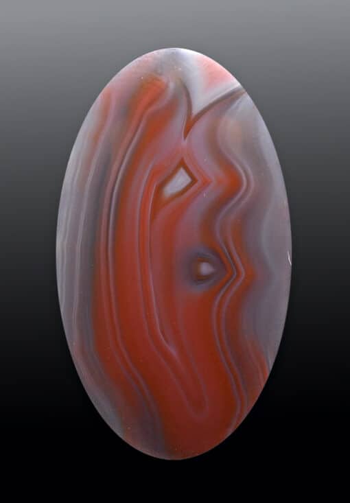 A red agate with swirls on it.