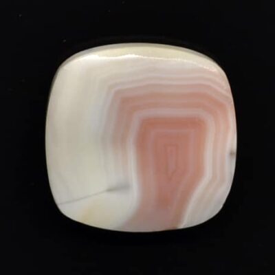A white and pink agate square cabochon.