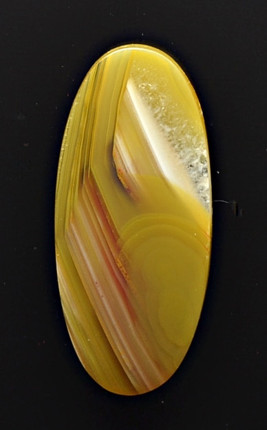 A yellow agate oval cabochon.