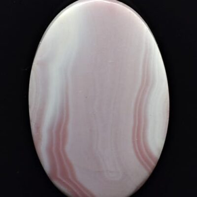 A pink agate oval on a black background.