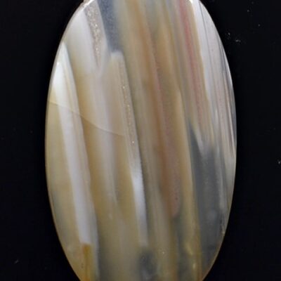 An oval agate stone on a black surface.