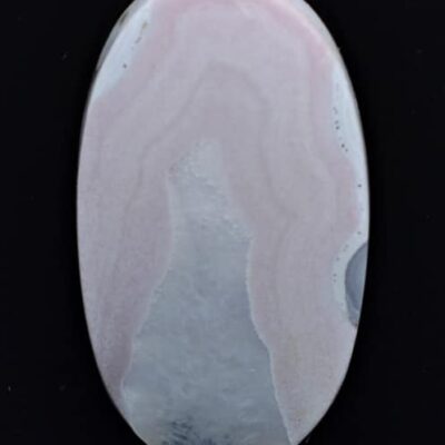 A pink agate stone on a black background.