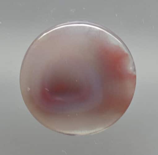 An agate stone with a red and purple color.