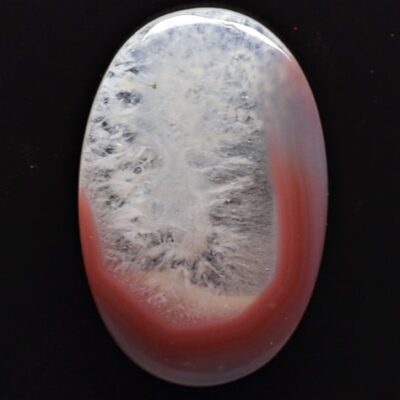 A red and white agate pendant on a black background.