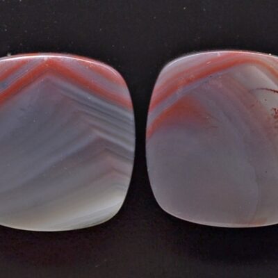 Two pieces of agate with red and white stripes.