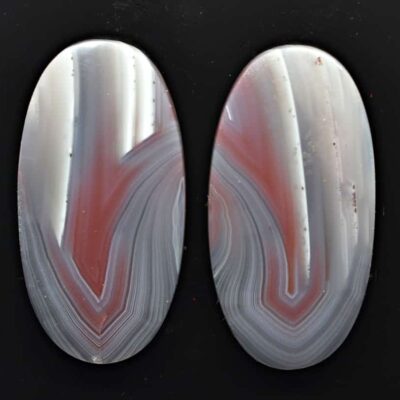 A pair of agate ovals on a black surface.