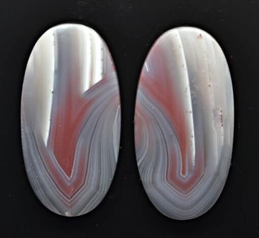 A pair of agate ovals on a black surface.