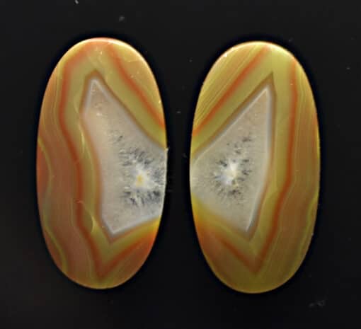 A pair of orange and yellow agate ovals.