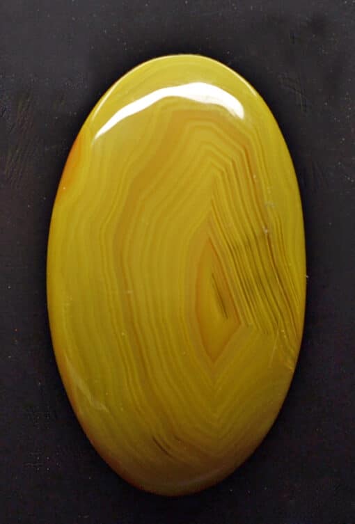 A yellow agate on a black background.