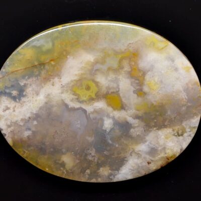 A round piece of agate on a black background.
