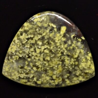 A yellow stone with yellow speckles on it.