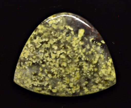 A yellow stone with yellow speckles on it.