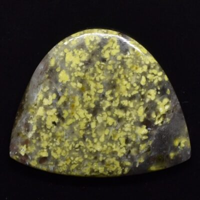 A piece of yellow jasper on a black background.