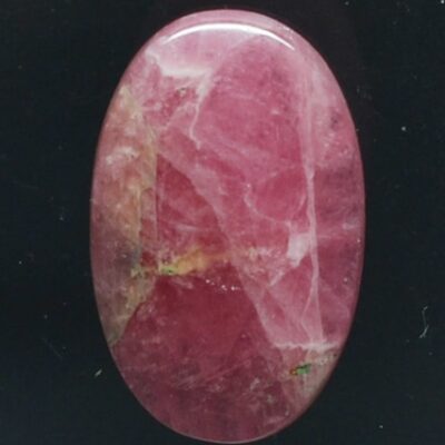 A pink stone on a black background.