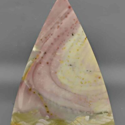 A triangle shaped piece of pink and yellow agate.