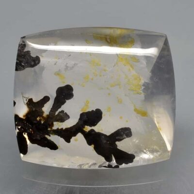 A piece of quartz with yellow and black spots on it.