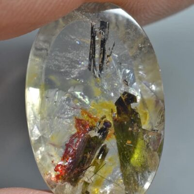 A person holding a piece of quartz with a flower on it.