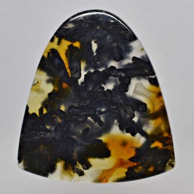 A black and yellow agate pendant on a white surface.