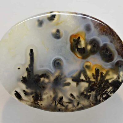 A round piece of agate with a black and white pattern.