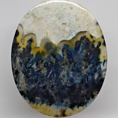 A blue and yellow agate on a white surface.