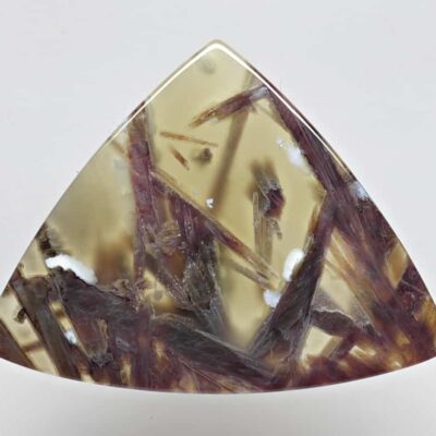 A triangular piece of jasper with brown and yellow streaks.
