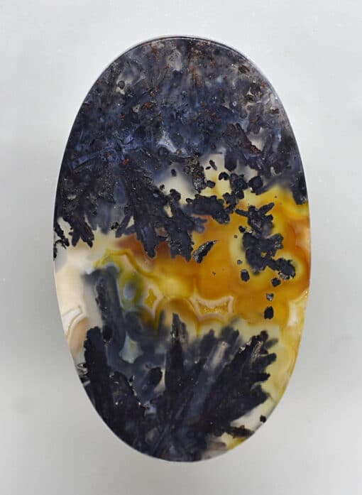 A piece of agate with a yellow and black pattern.