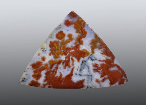 A triangular piece of orange and white agate.