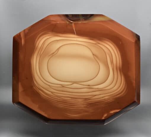 An octagon shaped piece of brown agate.