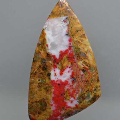 A piece of red and white jasper on a white background.