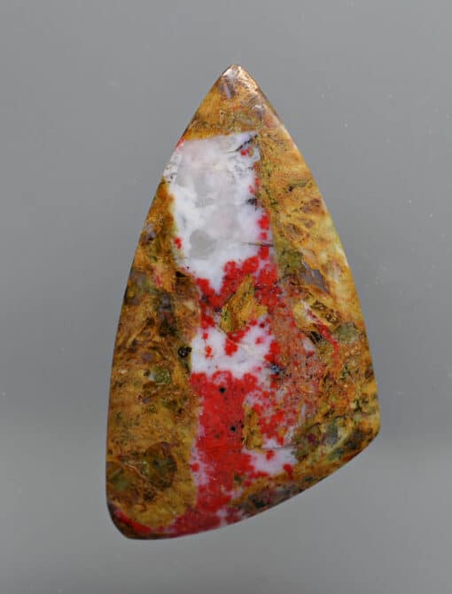 A piece of red and white jasper on a white background.