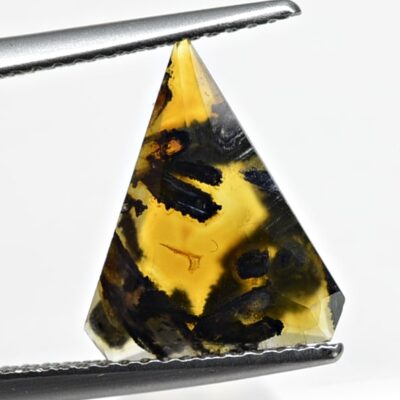 A triangle shaped piece of black and yellow amber.