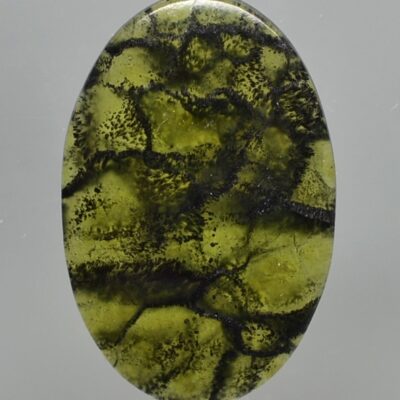 A green stone with black streaks on it.