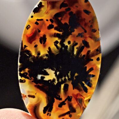 A person holding a piece of amber.