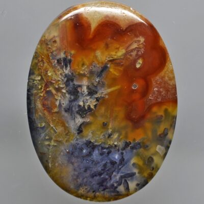 A round piece of agate with a colorful pattern on it.