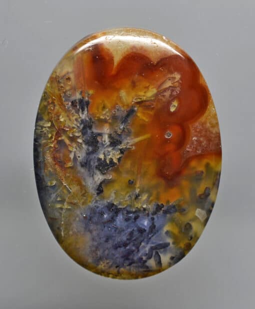 A round piece of agate with a colorful pattern on it.