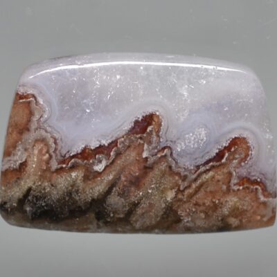 A piece of agate with a white and brown pattern.
