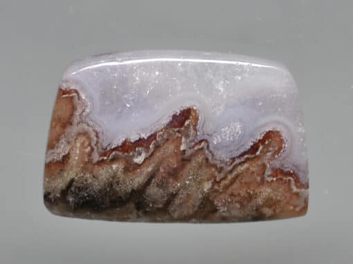 A piece of agate with a white and brown pattern.