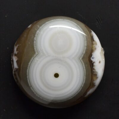 A white and brown agate ball with a number on it.