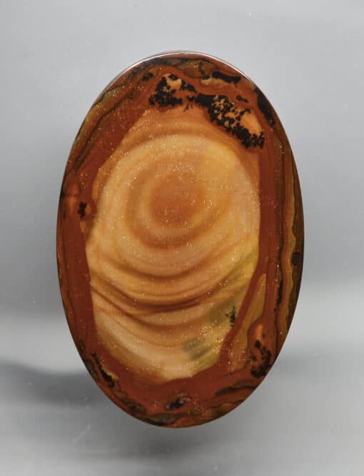 A circular piece of agate on a white surface.