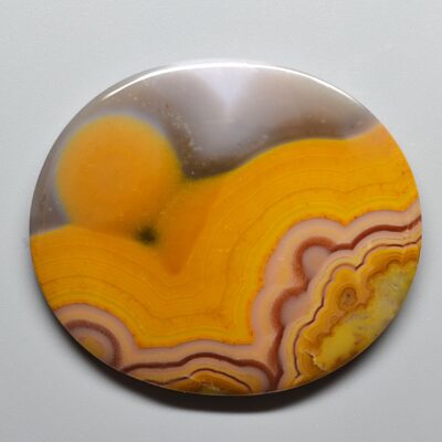 A circular piece of agate on a white surface.