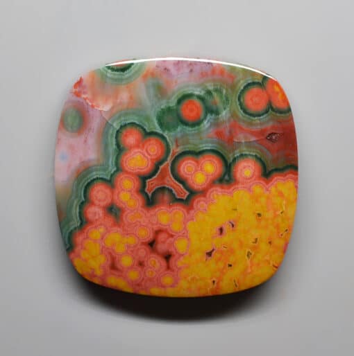 A square piece of green, yellow and orange agate.