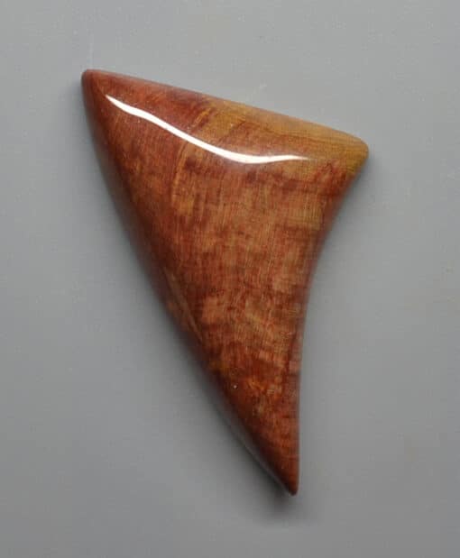 A piece of wood with a reddish brown color.