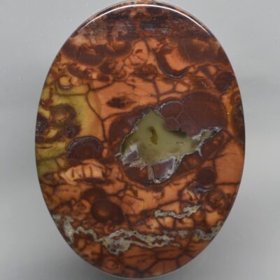 A circular piece of agate with a hole in it.