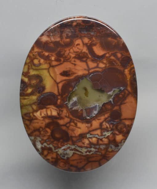 A circular piece of agate with a hole in it.