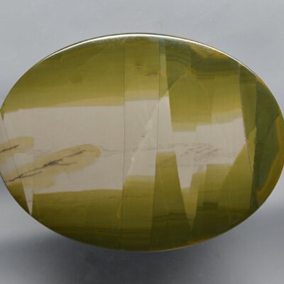 A circular piece of green and white agate.