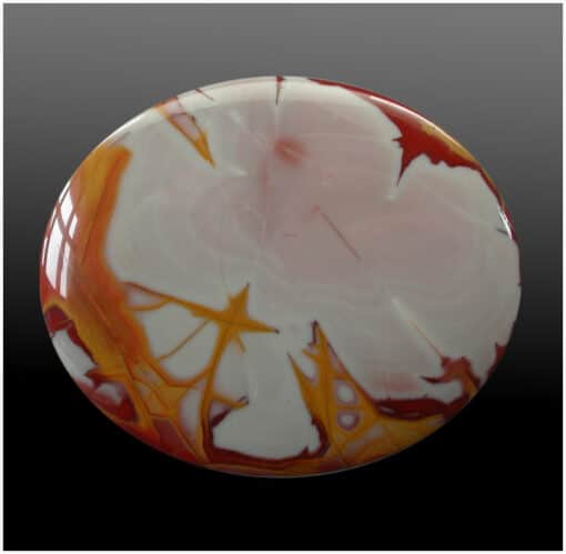 A red and white marbled button on a black background.