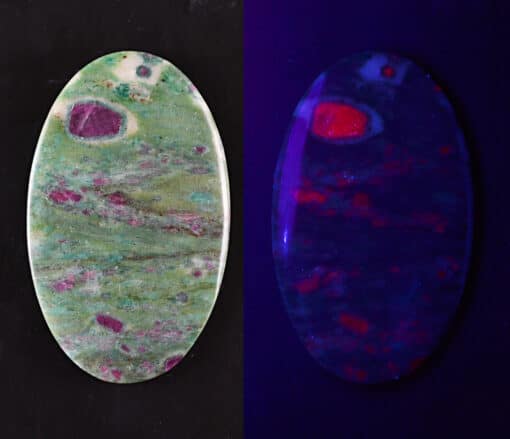 Two oval shaped pieces of opal on a black background.