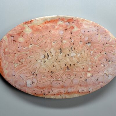A pink marble plate on a white background.