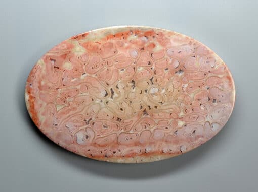 A pink marble plate on a white background.