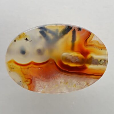 A piece of agate with a yellow and orange design.
